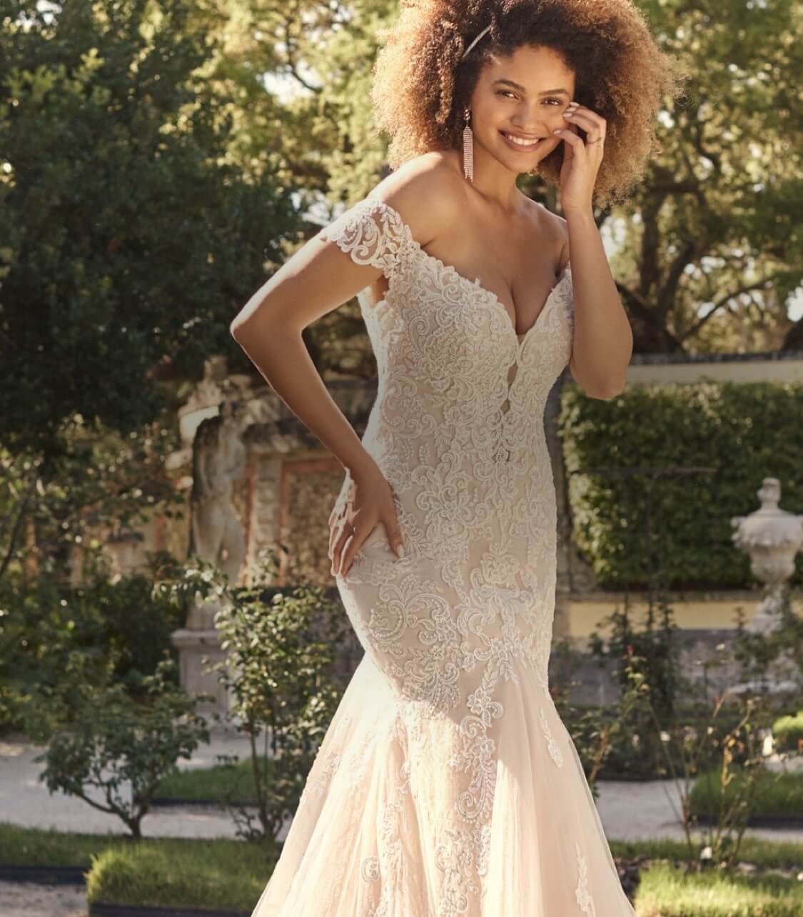 Model wearing a white gown. Mobile image